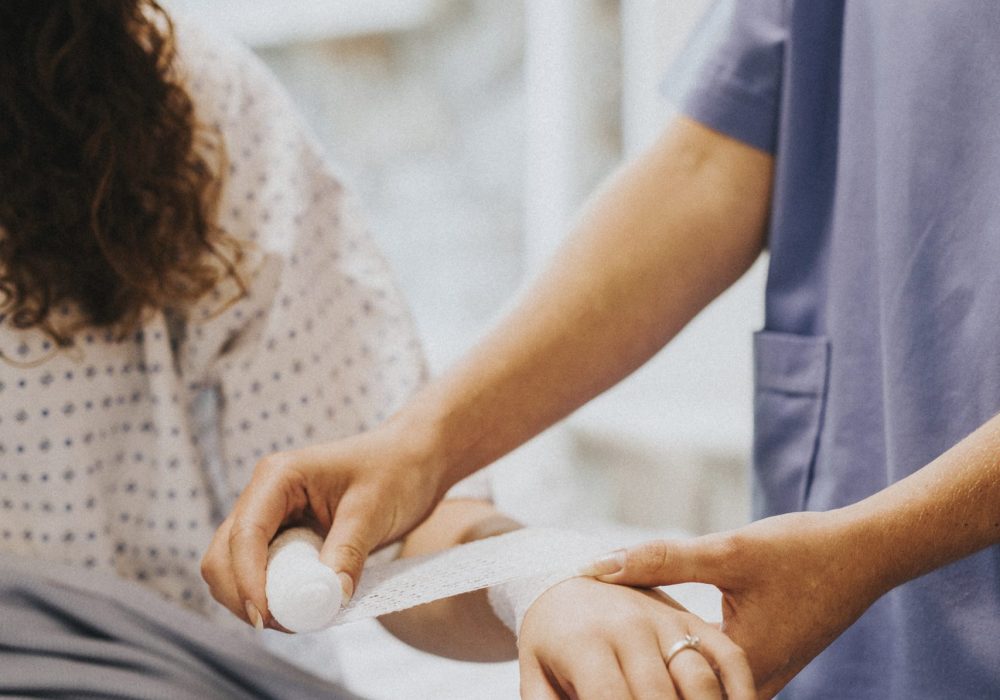 Nurse bandaging the patients arm